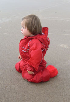 Iona enjoying the beach in her Puddle Suit and Togz Booties
