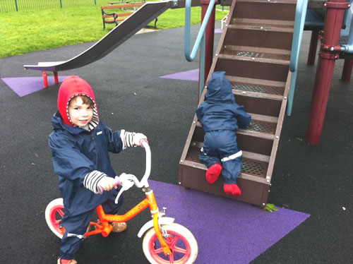 Alexander and Eliza playing in the park in Ocean Suits and Togz booties