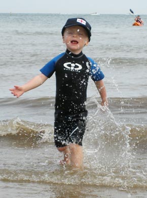 Evan enjoying splashing in the waves!