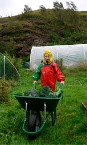 Sandy in Ocean jacket and dungarees picking veg