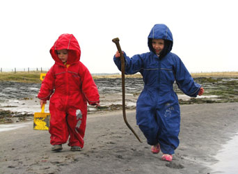 Gabby & Philip playing in Puddle Suits on the beach