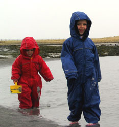 Gabby & Philip playing in Puddle Suits on the beach