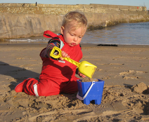 Seely on the beach in Ocean Dungarees