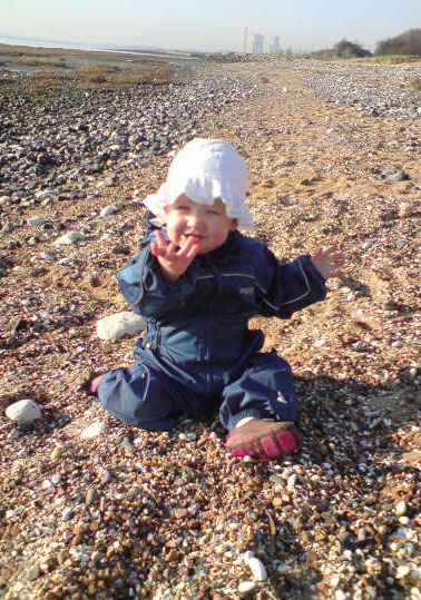 Sofia having fun on the beach in her regatta Puddle Suit