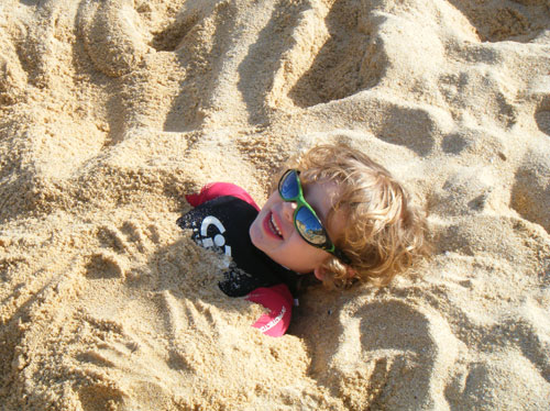 Thomas buried in the beach in TWF wetsuit!
